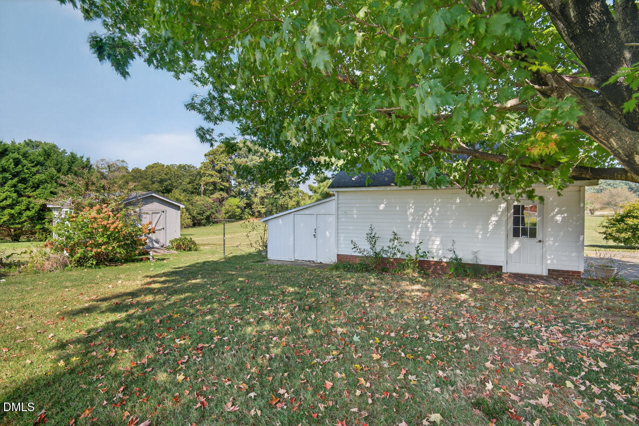 720 Roxboro Road Haw River, NC 27258 - Photo 42 of 55 a backyard of a house with plants and a large tree