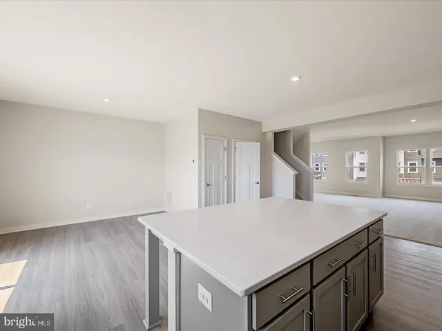 a kitchen with a wooden floor and a hallway