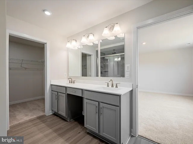 a bathroom with a double vanity sink and a mirror