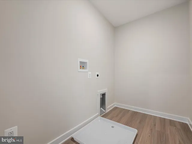 a view of a room with wooden floor and white walls