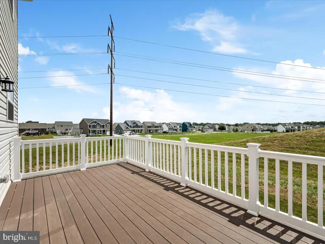 a view of a balcony with wooden floor