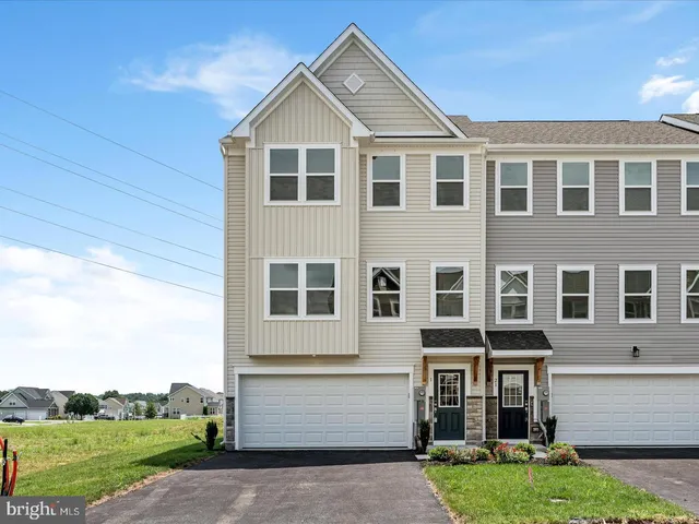 a view of a big house with a yard