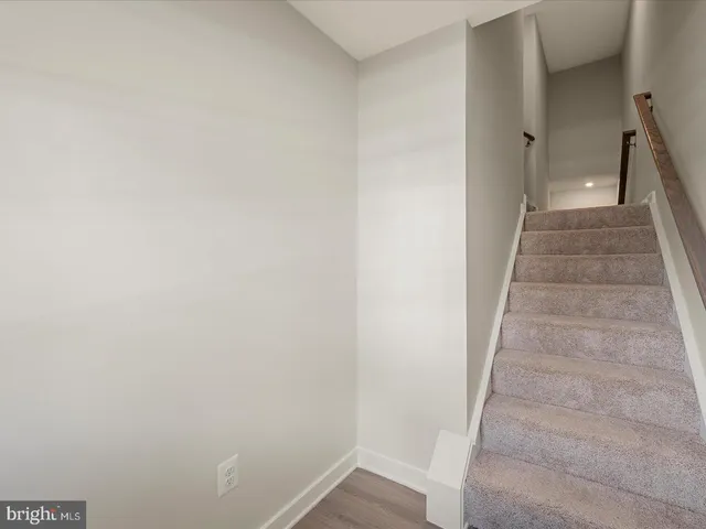 a view of a hallway with wooden floor and entryway