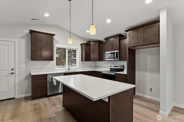 a kitchen with a refrigerator stove and sink