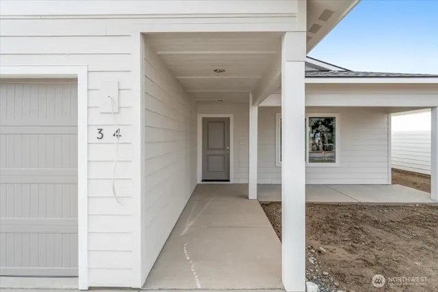 a view of an empty room with a kitchen