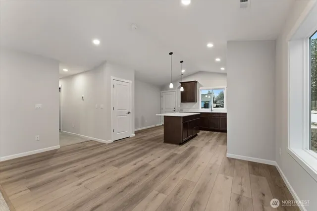 a kitchen with a sink a counter top space stainless steel appliances and cabinets