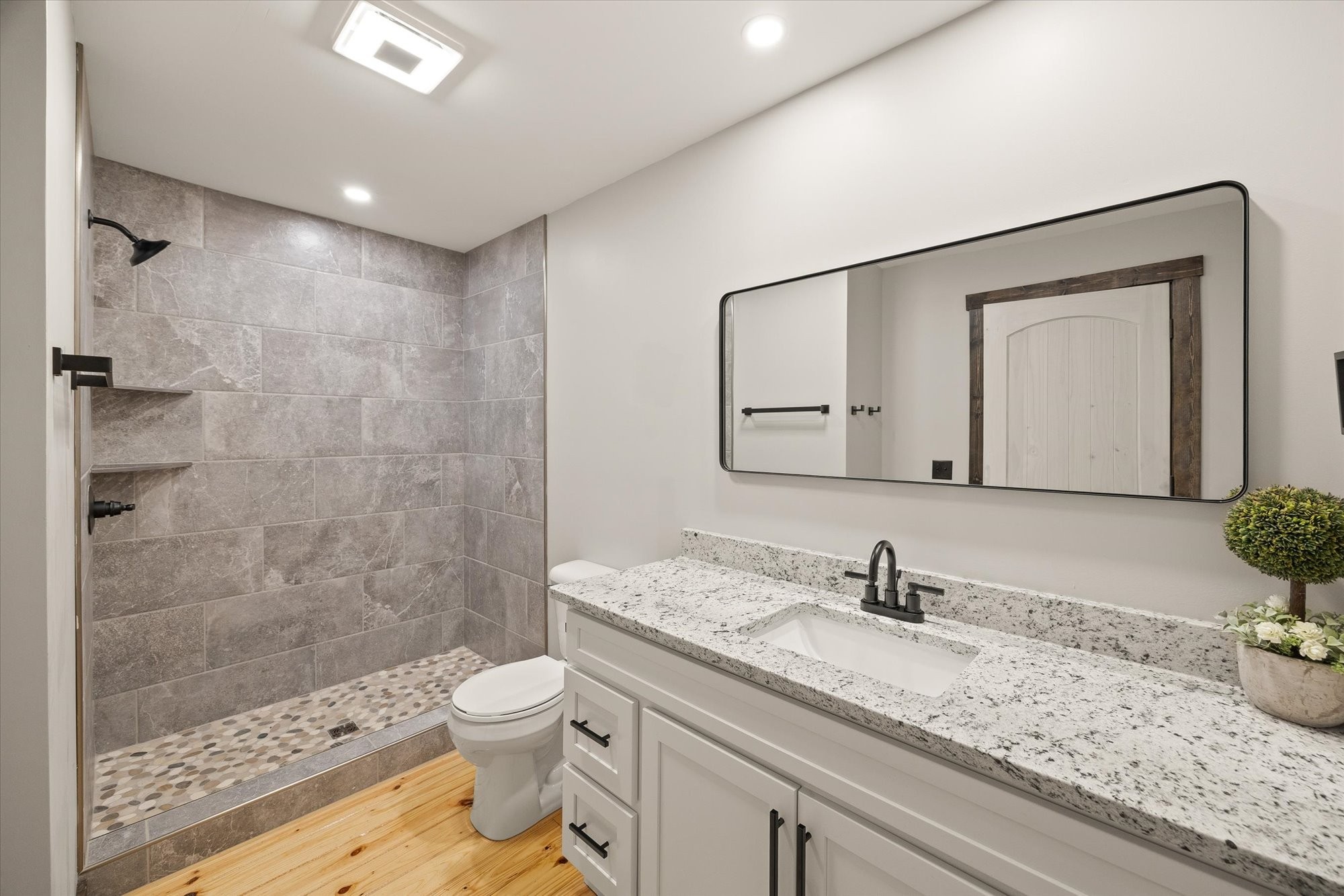 4221 New Hope Road Celina, TN 38551 - Photo 32 of 52 a bathroom with a granite countertop sink a toilet and a shower