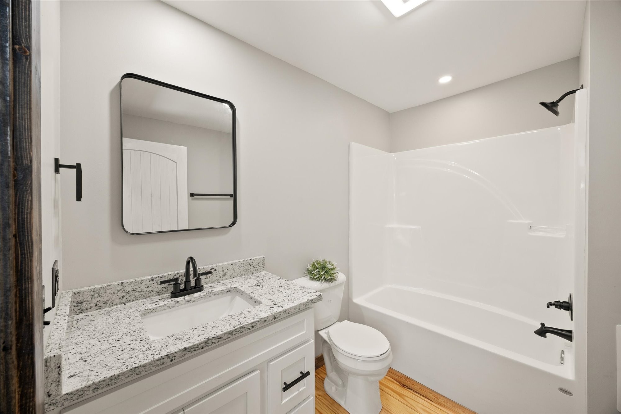 4221 New Hope Road Celina, TN 38551 - Photo 33 of 52 a bathroom with a granite countertop sink mirror toilet and bathtub