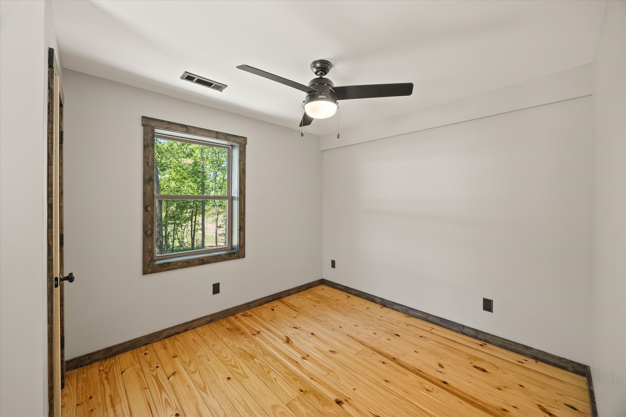 4221 New Hope Road Celina, TN 38551 - Photo 34 of 52 a view of empty room with wooden floor and fan