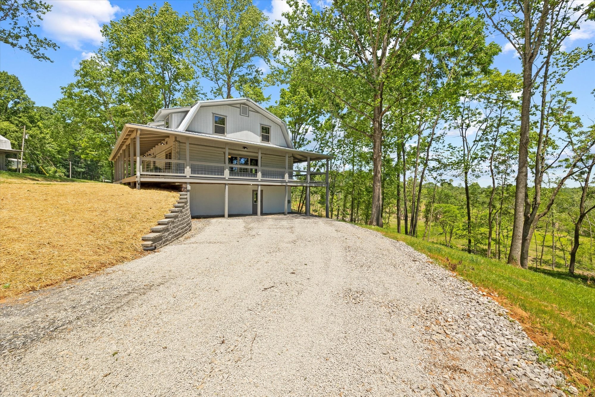 4221 New Hope Road Celina, TN 38551 - Photo 7 of 52 a front view of a house with a yard and large trees