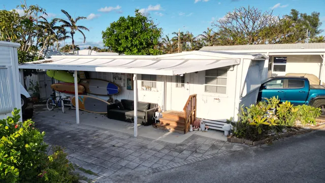 a view of a patio with table and chairs potted plants