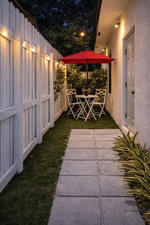 a view of a patio with table and chairs