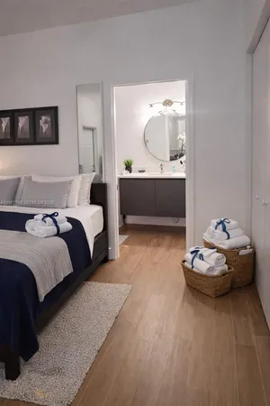 a bedroom with a bed and a large mirror