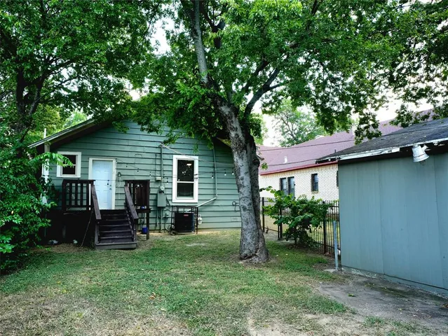 a view of backyard of house with green space