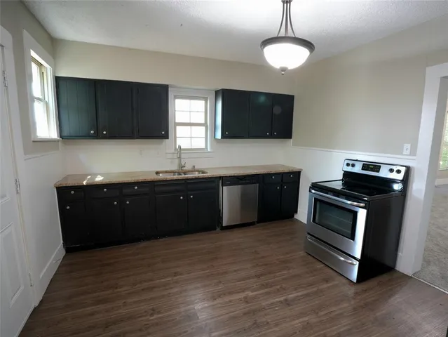 a kitchen with a sink and a stove top oven