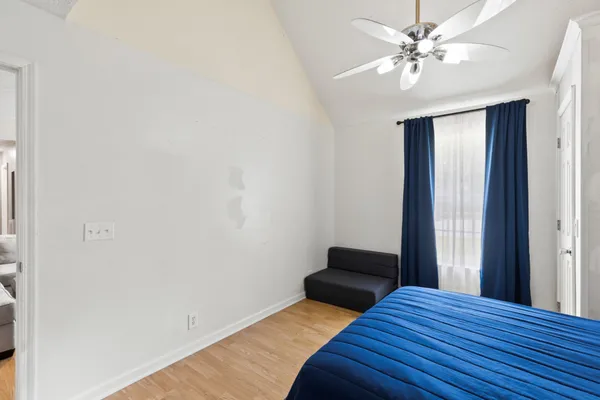 a bedroom with a bed and a window