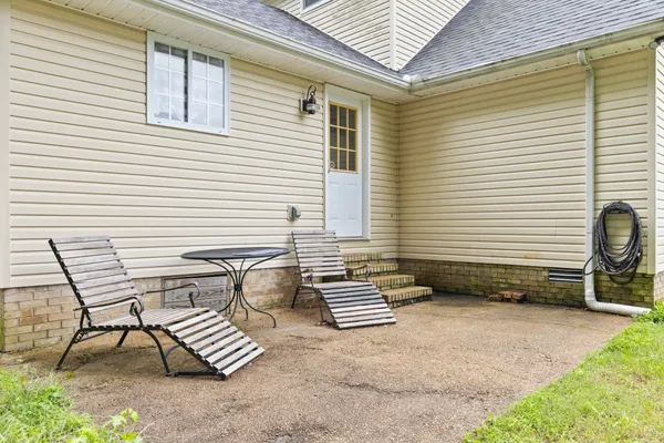 a view of a chairs and table in patio