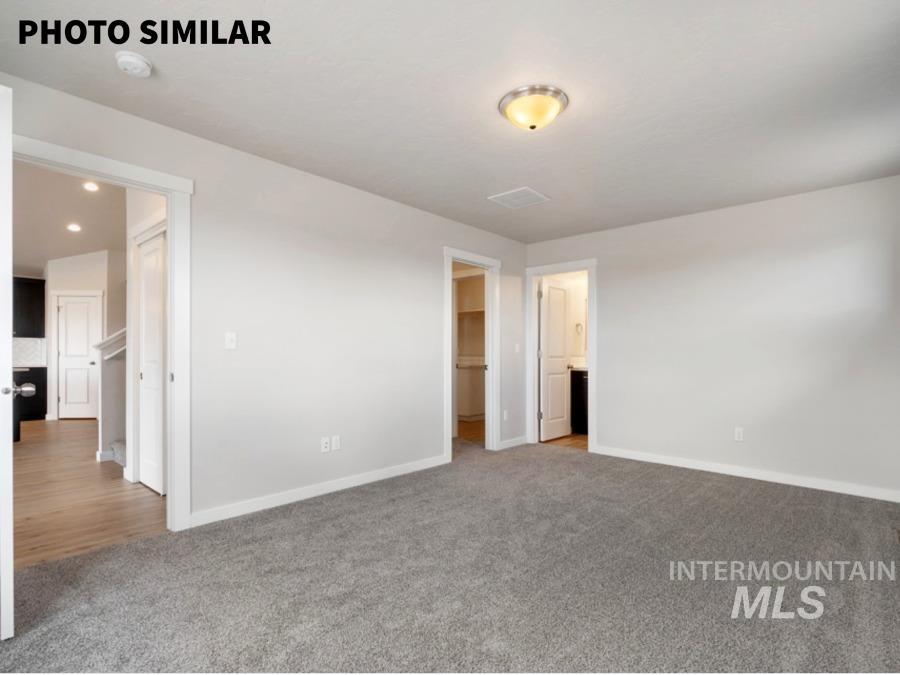 925 Twilight Weiser, ID 83672 - Photo 18 of 31 Spacious room featuring gray carpeting, light-toned walls, and a semi-flush mount ceiling light