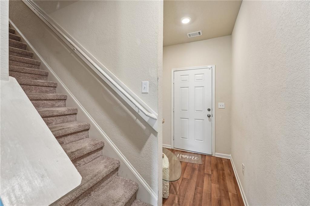 10933 Wheeler Trace Hampton, GA 30228 - Photo 5 of 22 a view of a hallway with staircase