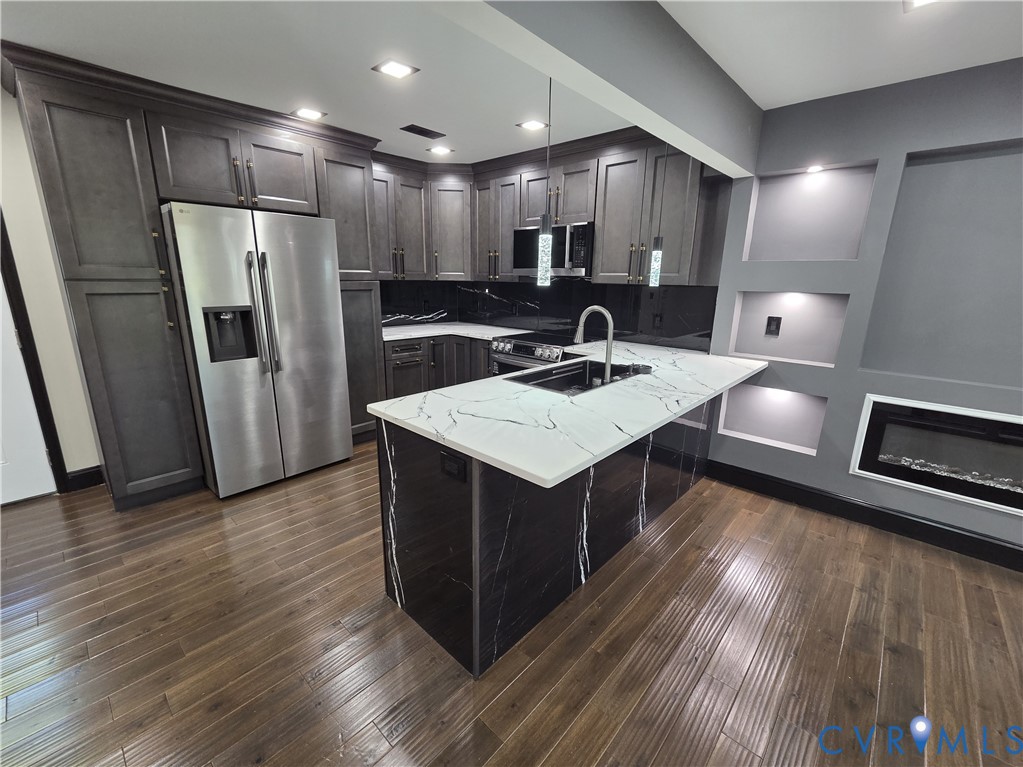 2420 Yarnell Road Henrico, VA 23231 - Photo 11 of 25 a kitchen with kitchen island a sink appliances and cabinets