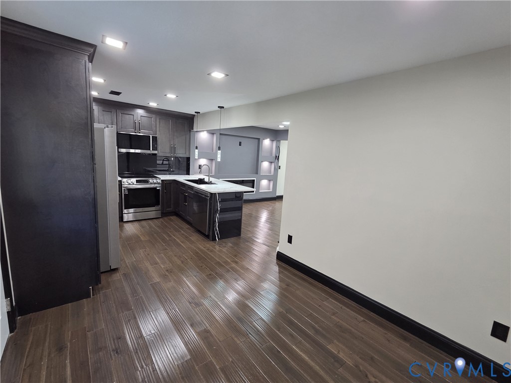 2420 Yarnell Road Henrico, VA 23231 - Photo 12 of 25 a kitchen with stainless steel appliances a sink a stove top oven a counter space and cabinets
