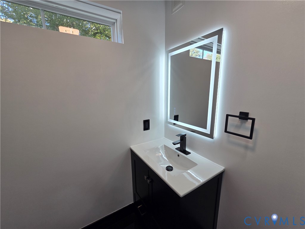 2420 Yarnell Road Henrico, VA 23231 - Photo 18 of 25 a bathroom with a sink and a mirror