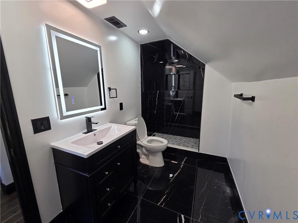 2420 Yarnell Road Henrico, VA 23231 - Photo 21 of 25 a bathroom with a double vanity sink toilet mirror and shower