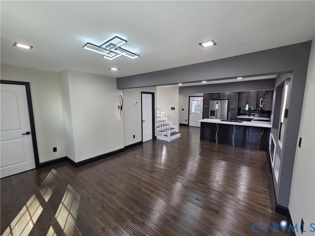 2420 Yarnell Road Henrico, VA 23231 - Photo 8 of 25 a view of a big room with wooden floor and a kitchen