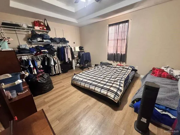 a bedroom with a bed closet and a window