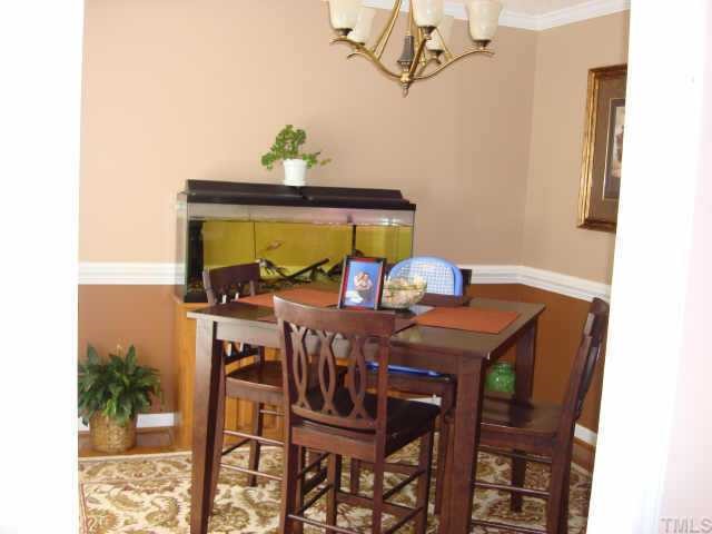 2900 Livery Way Raleigh, NC 27603 - Photo 3 of 10 a view of a dining room with furniture and chandelier