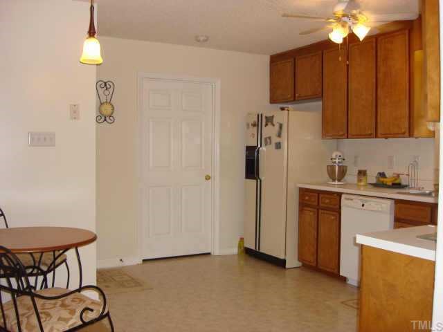 2900 Livery Way Raleigh, NC 27603 - Photo 7 of 10 a kitchen with stainless steel appliances granite countertop a refrigerator a sink a stove and a wooden floors