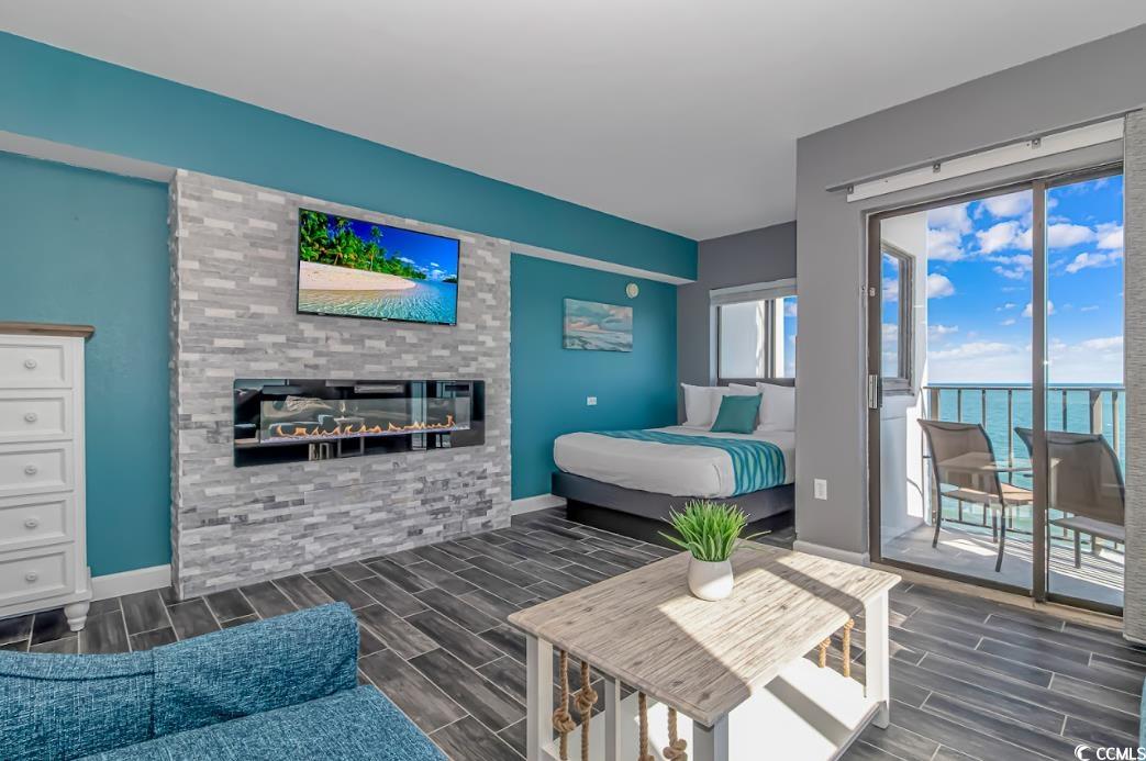 1605 South Ocean Boulevard, Unit 603 Myrtle Beach, SC 29577 - Photo 5 of 40 Bedroom featuring wood tiled floors, a fireplace, and access to outside