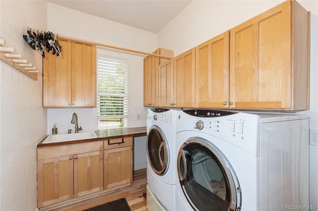 a utility room with sink dryer and washer