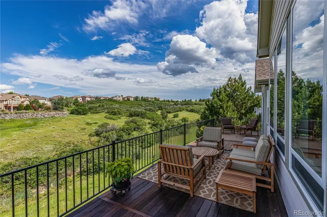 a view of a balcony with two chairs
