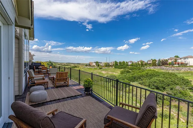 a view of a chair and tables in the balcony