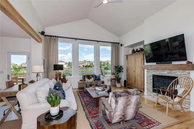 a living room with furniture a fireplace and a flat screen tv
