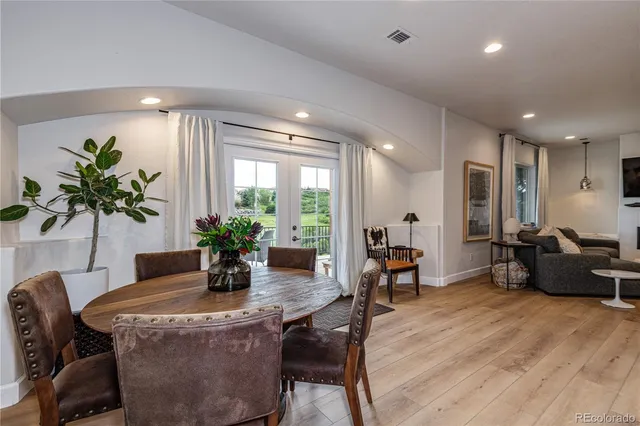 a dining room with furniture and wooden floor