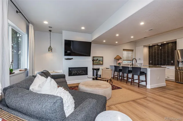 a living room with furniture fireplace and flat screen tv