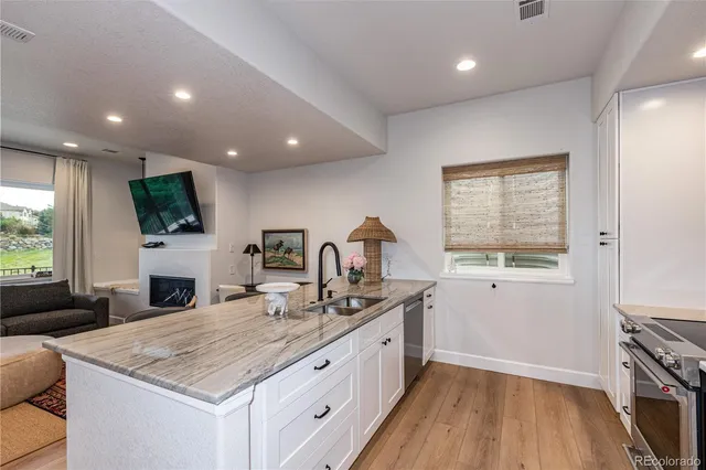 a kitchen with sink stove and refrigerator
