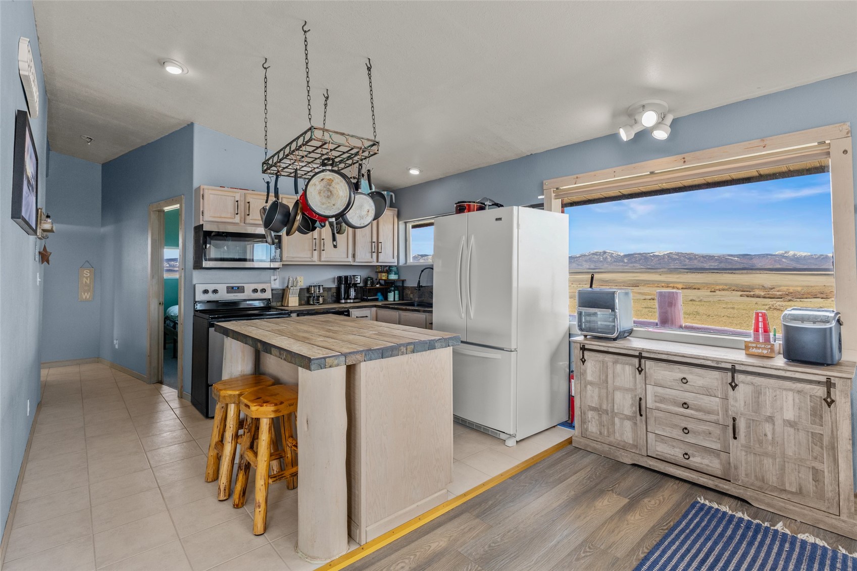 151 Jcr 26 Walden, CO 80430 - Photo 9 of 28 a kitchen with stainless steel appliances granite countertop a stove a refrigerator and a wooden floors