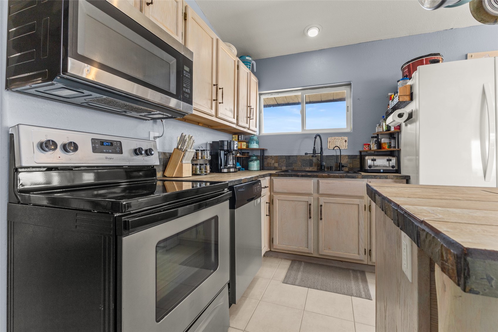 151 Jcr 26 Walden, CO 80430 - Photo 10 of 28 a kitchen with stainless steel appliances granite countertop a stove and a microwave