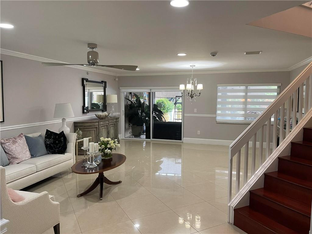 22909 Old Inlet Bridge Drive Boca Raton, FL 33433 - Photo 2 of 9 a living room with furniture and a potted plant