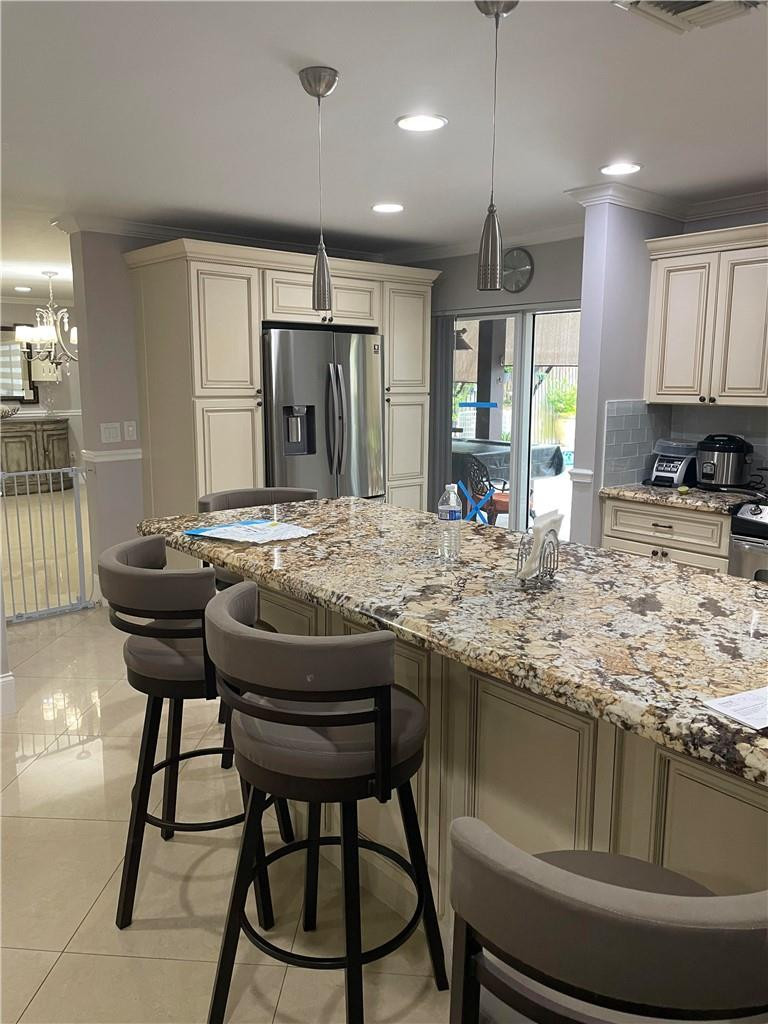 22909 Old Inlet Bridge Drive Boca Raton, FL 33433 - Photo 4 of 9 a kitchen with kitchen island granite countertop wooden cabinets and counter space