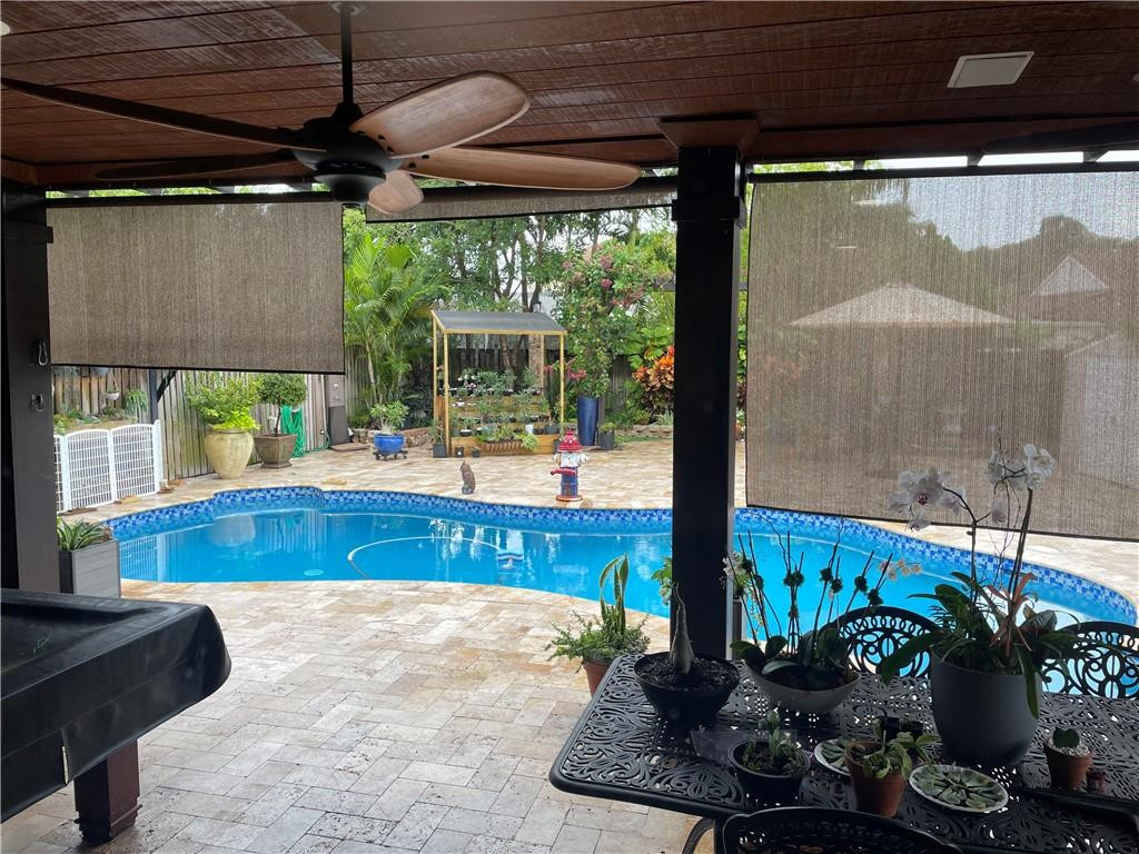 22909 Old Inlet Bridge Drive Boca Raton, FL 33433 - Photo 5 of 9 a living room with patio furniture and a potted plant