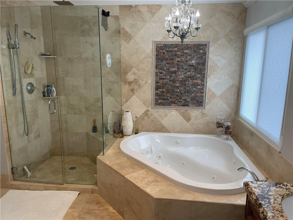 22909 Old Inlet Bridge Drive Boca Raton, FL 33433 - Photo 7 of 9 a bathroom with a bathtub and shower