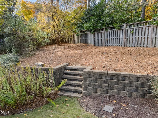 a front view of a house with a garden and plants