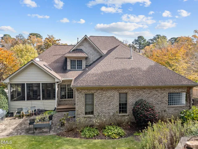 a aerial view of a house with a yard and potted plants