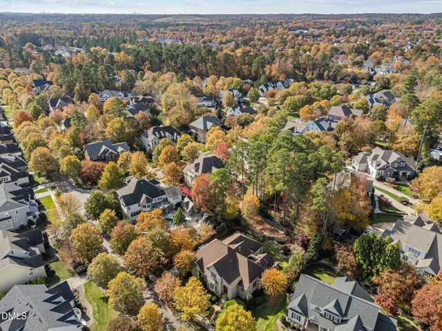 an aerial view of residential house with parking and yard