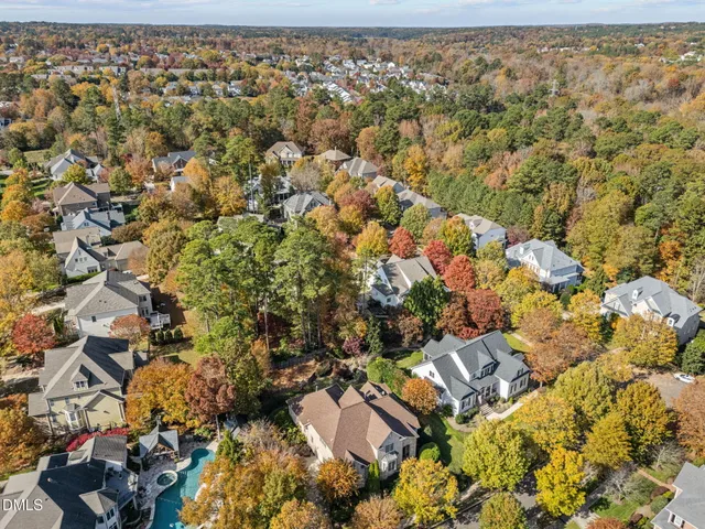 a bathroom with a toilet a sink a mirror and a window