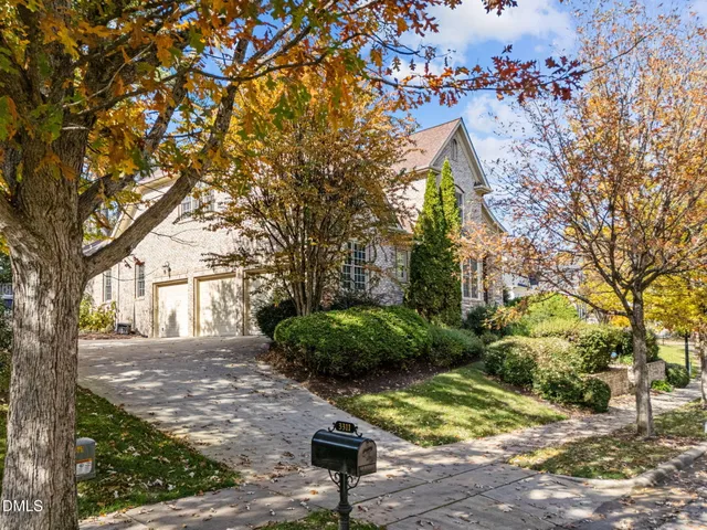 a view of a dining room with furniture a chandelier and wooden floor